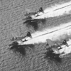 Three floatplanes landing on water. click here for full image